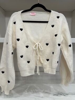 Pink Lily small tie white cardigan with black hearts.  Like new